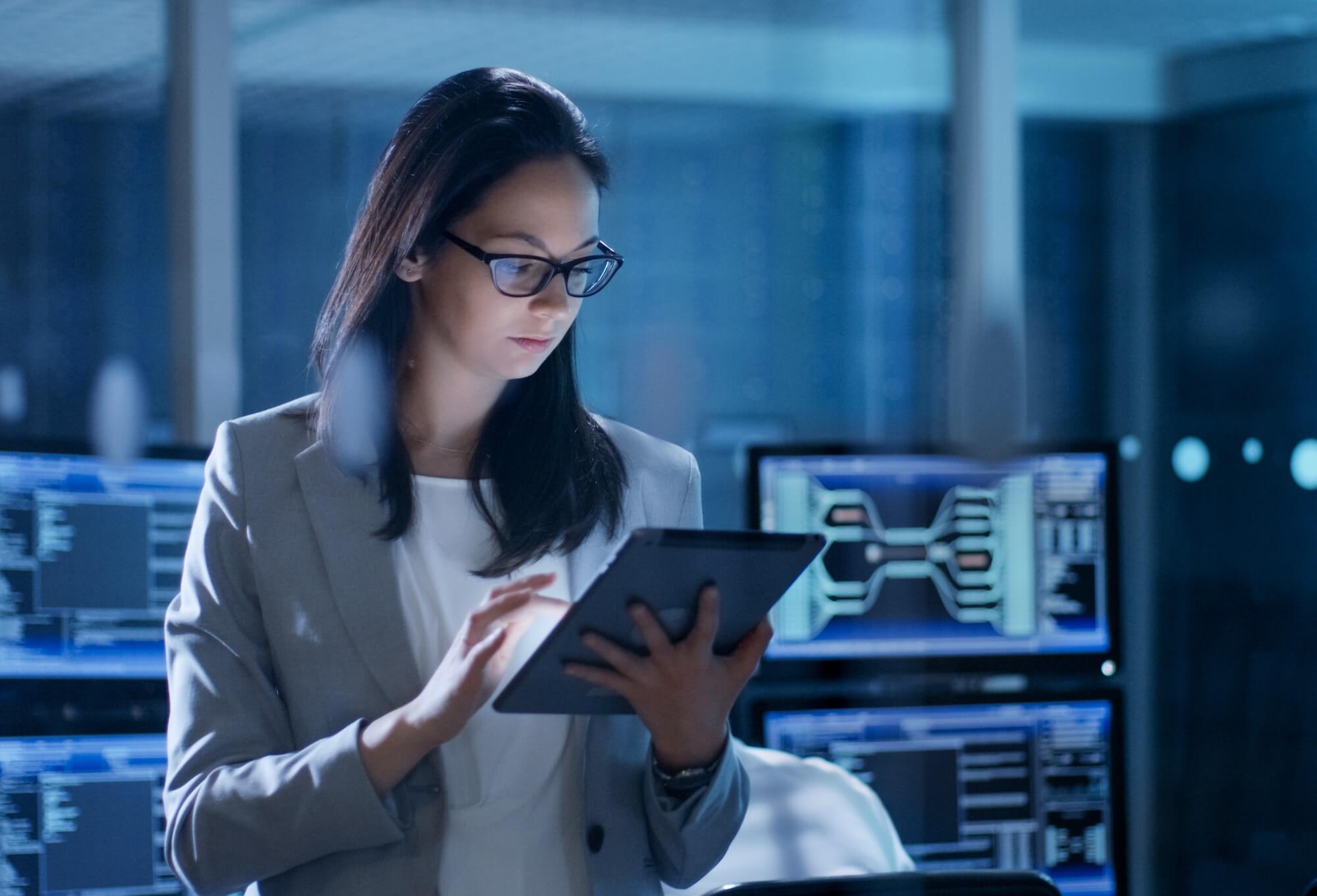 A woman in a data center using a tablet